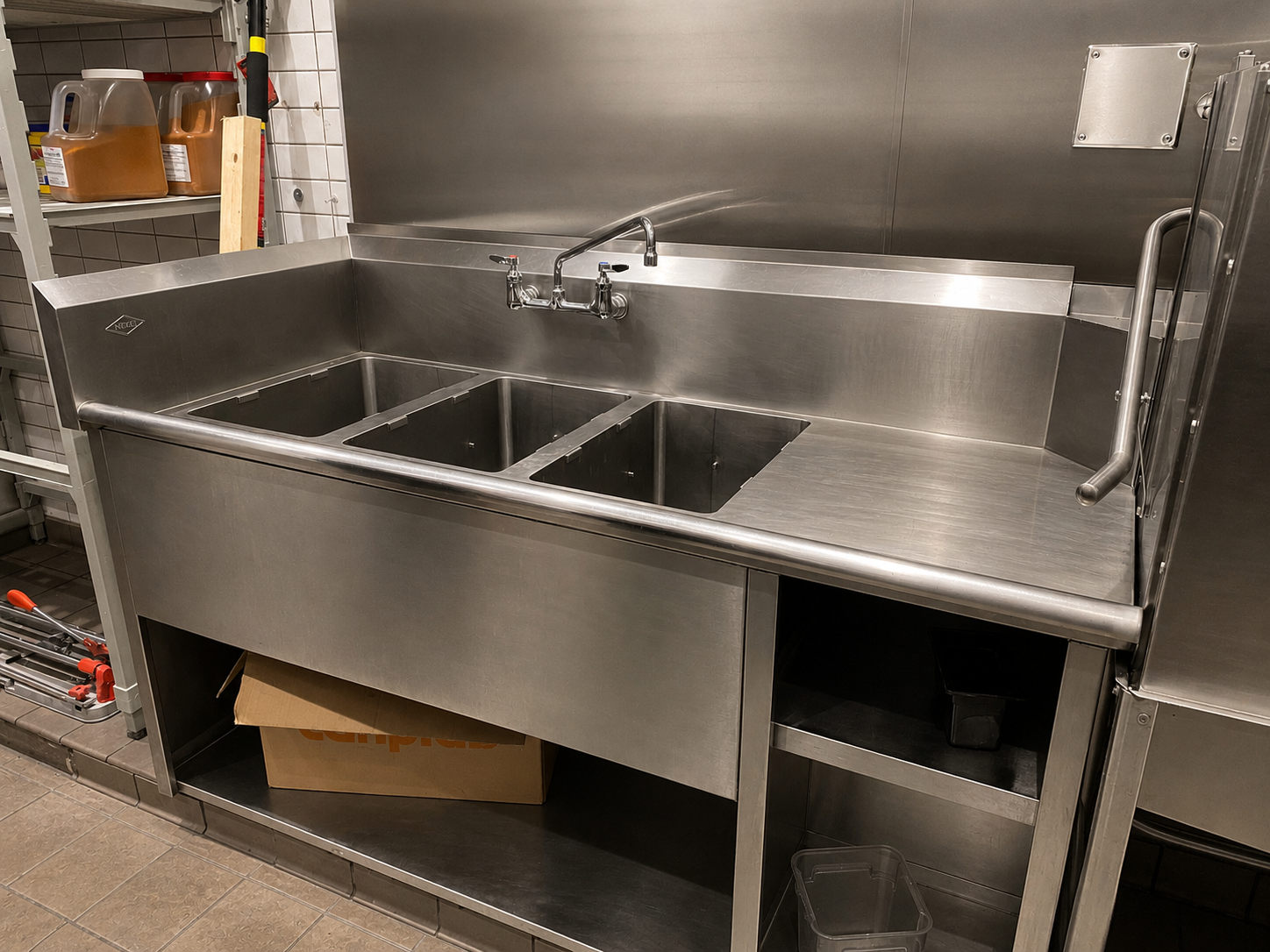 Commercial stainless steel three-compartment sink installation in Abbotsford restaurant kitchen